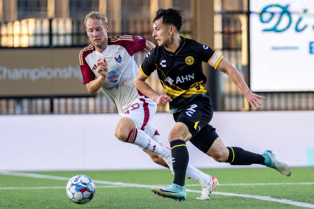 Danny Griffin dribbles away from North Carolina's Garrett McLaughlin in the Hounds' 1-1 draw on May 18, 2024 at Highmark Stadium. (Photo: Chris Cowger/Riverhounds SC)
