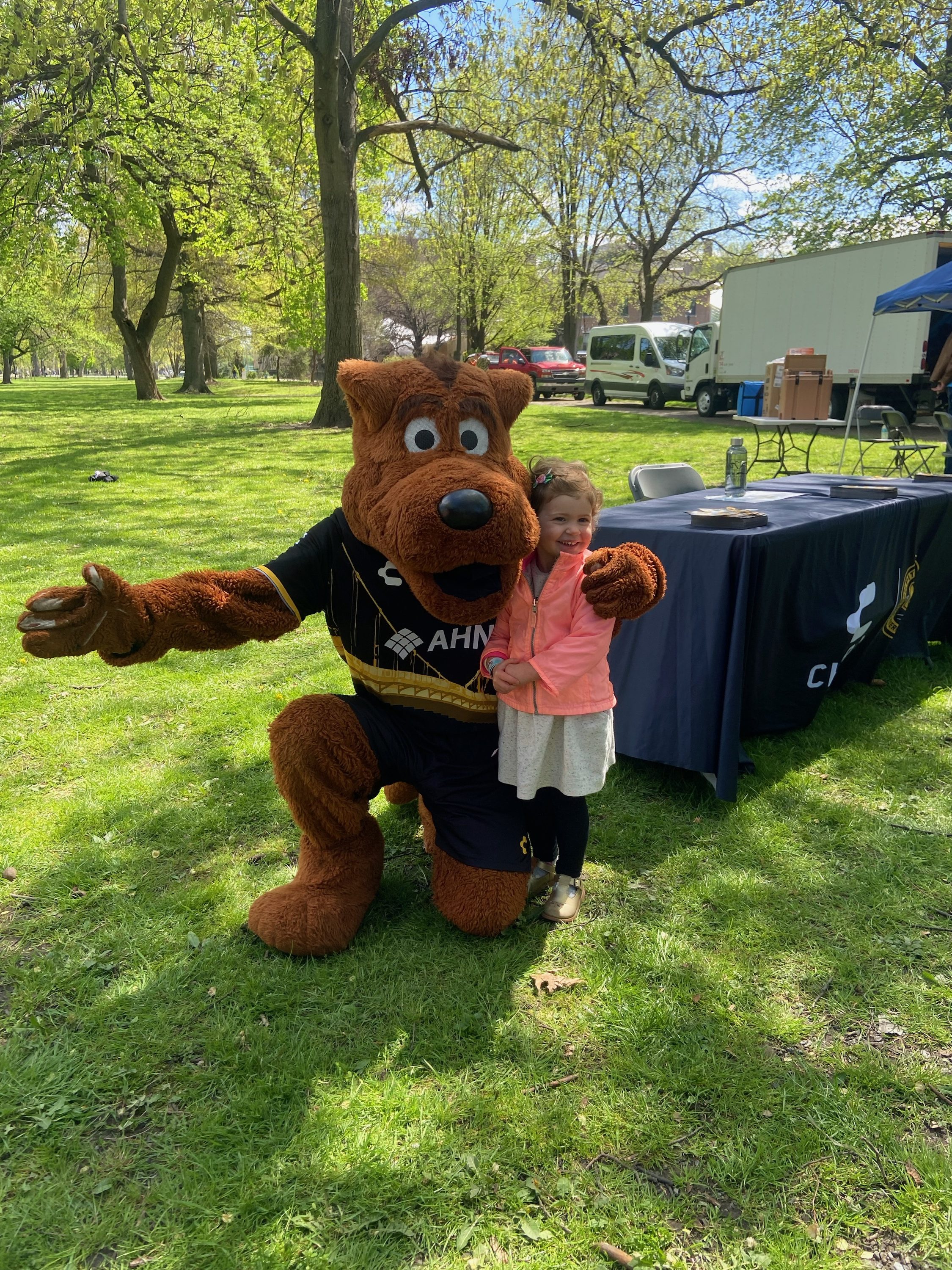 Picture of Pittsburgh Riverhounds Mascot AMO, with a fan at  community event 