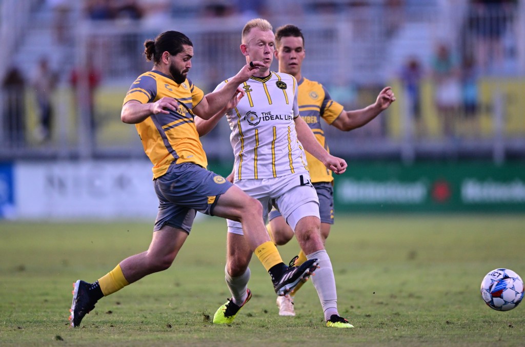 Riverhounds players Jackson Walti and Robbie Mertz converge on the Charleston Battery's Chris Allan in the teams' 0-0 draw on June 8, 2024 at Patriots Point Soccer Complex in Mount Pleasant, S.C. (Photo: Charleston Battery)