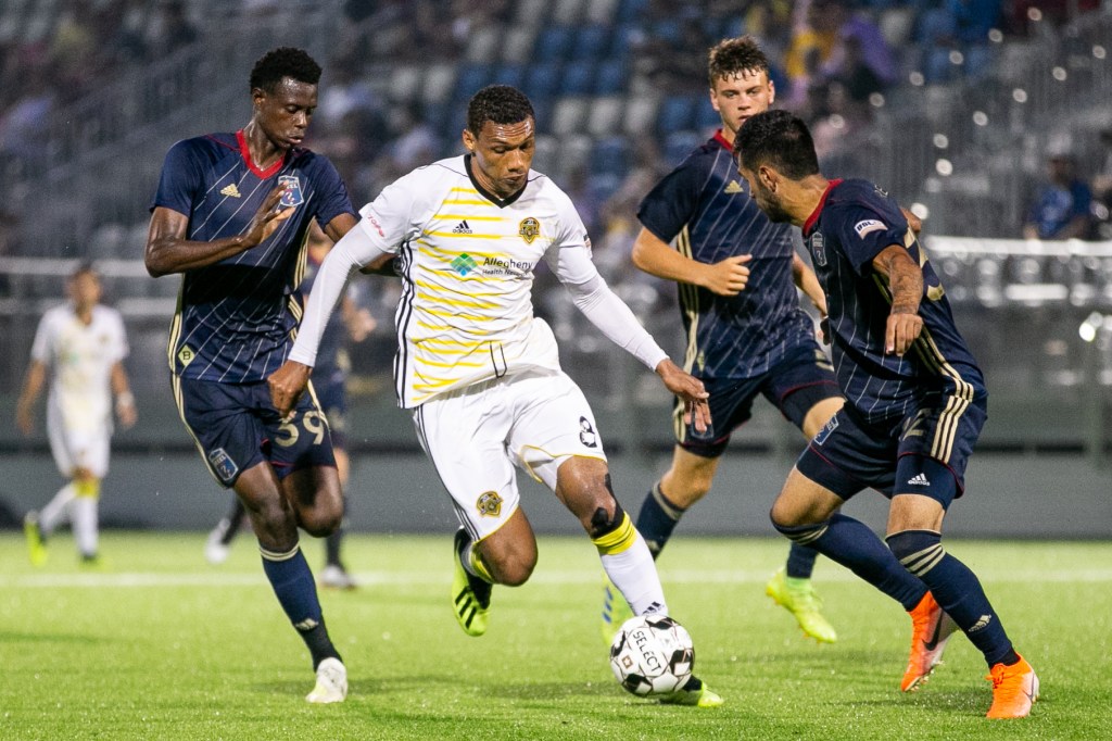 Pittsburgh Riverhounds striker Steevan Dos Santos dribbling a ball during a game in the 2019 season