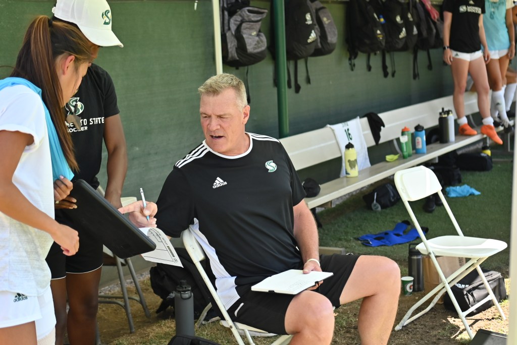 Sacramento State University's Head coach Randy Dedini making mid game adjustments 