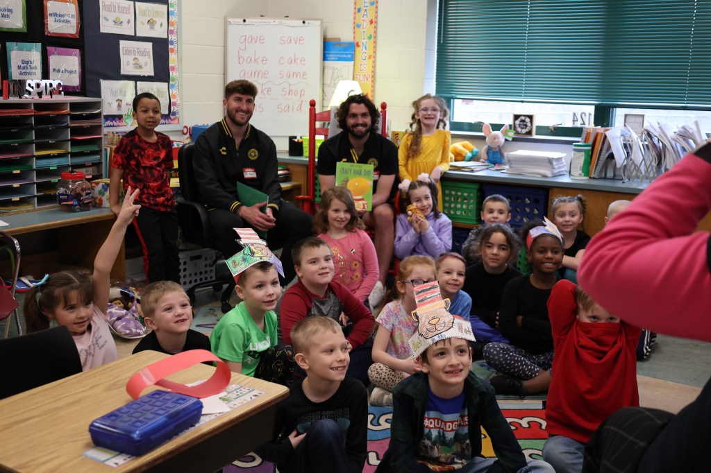 Picture of Pittsburgh Riverhounds players making appearances for a local school in the greater Pittsburgh region as part of the read across America campaign.