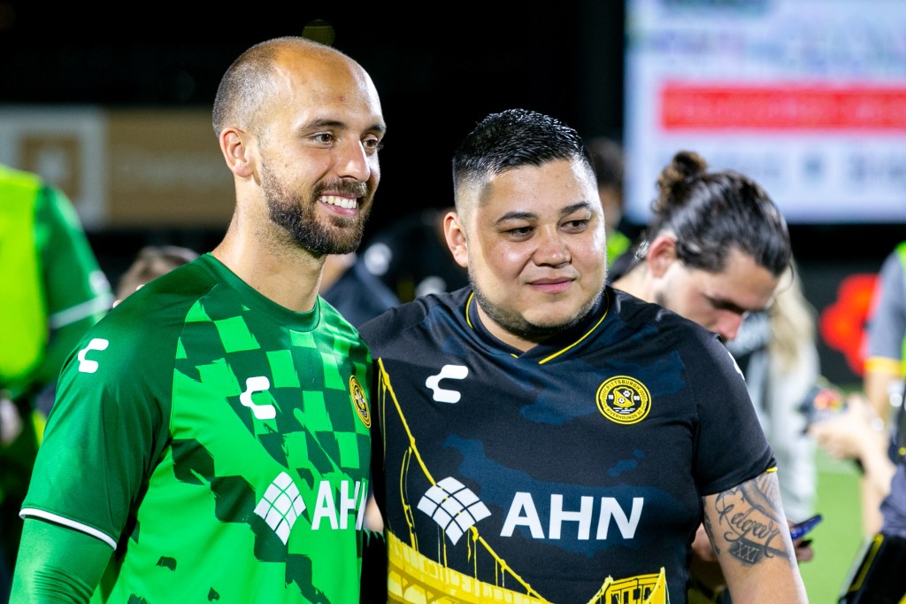 Hounds goalkeeper Gabriel Perrotta takes a photo with a fan after the team's U.S. Open Cup match against FC Tulsa on May 7, 2024 at Highmark Stadium. (Photo: Chris Cowger/Riverhounds SC)