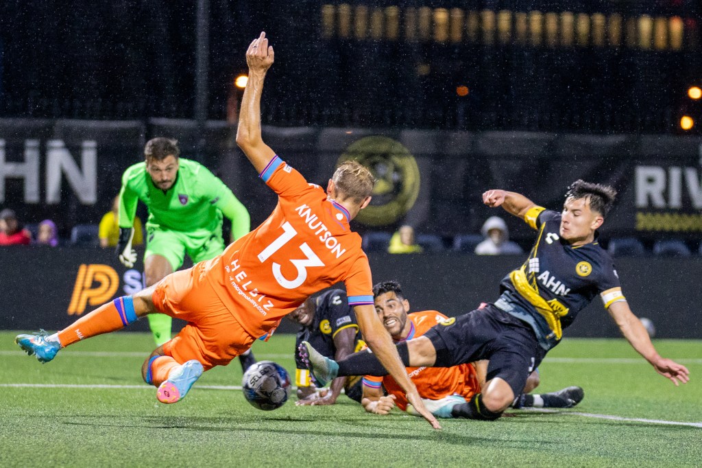 The Riverhounds' Danny Griffin has his sliding attempt on goal blocked by Miami FC's Daltyn Knutson in the Hounds' 1-0 win on May 4, 2024 at Highmark Stadium. (Photo: Chris Cowger/Riverhounds SC)