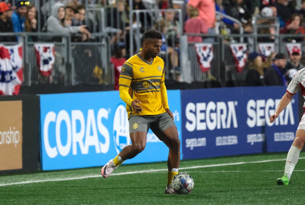 Hounds wing back Langston Blackstock plays a pass in the team's 2-0 win over Loudoun United FC on Oct. 19, 2024 at Segra Field in Leesburg, Va. (Photo courtesy of Loudoun United FC)