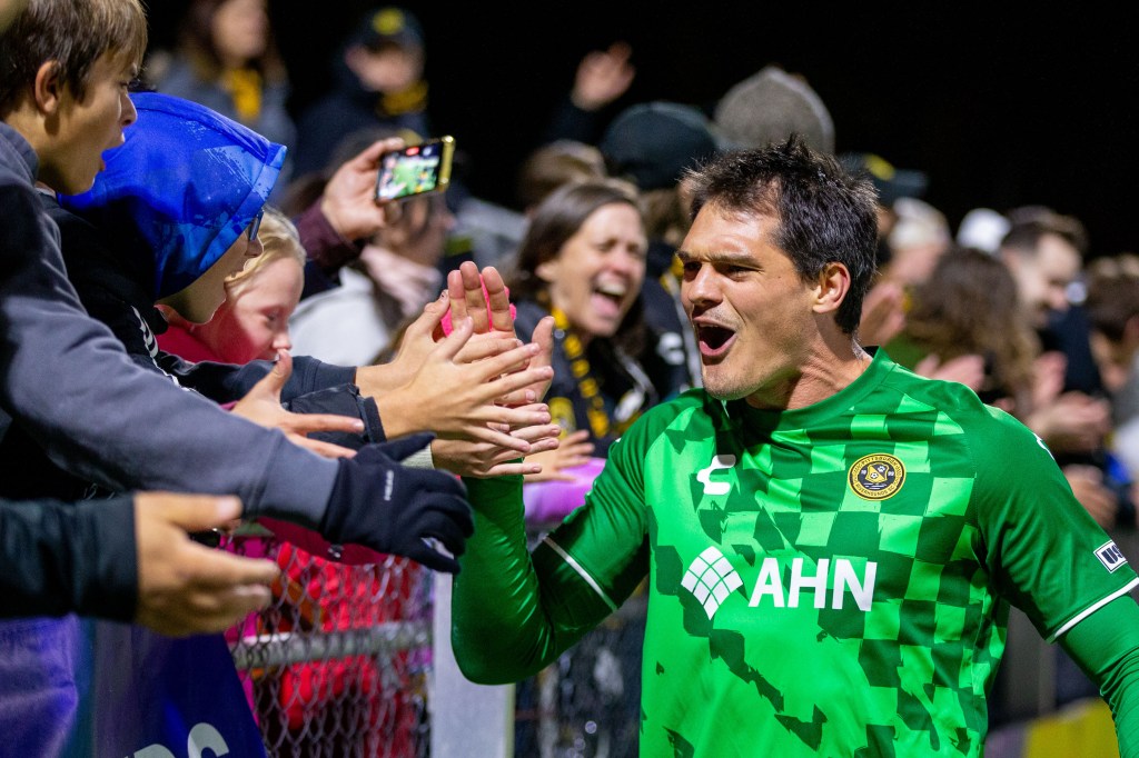 Riverhounds goalkeeper Eric Dick celebrates with fans after the Hounds' 2-0 win over El Paso Locomotive FC on Oct. 26, 2024, at Highmark Stadium in Pittsburgh. (Photo: Chris Cowger/Riverhounds SC)