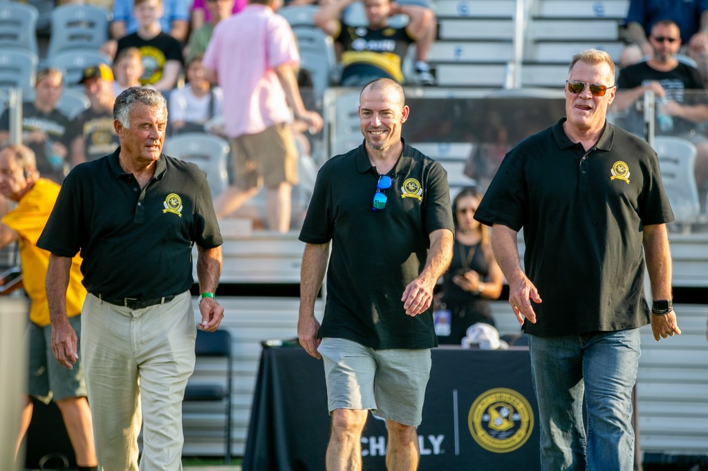 Paul Child, Gary DePalma and Randy Dedini, the Riverhounds Hall of Fame's Class of 2024, step onto the field for pregame ceremonies of the Hounds' 5-0 win over Oakland Roots SC on July 13, 2024, at Highmark Stadium. (Photo: Chris Cowger/Riverhounds SC)