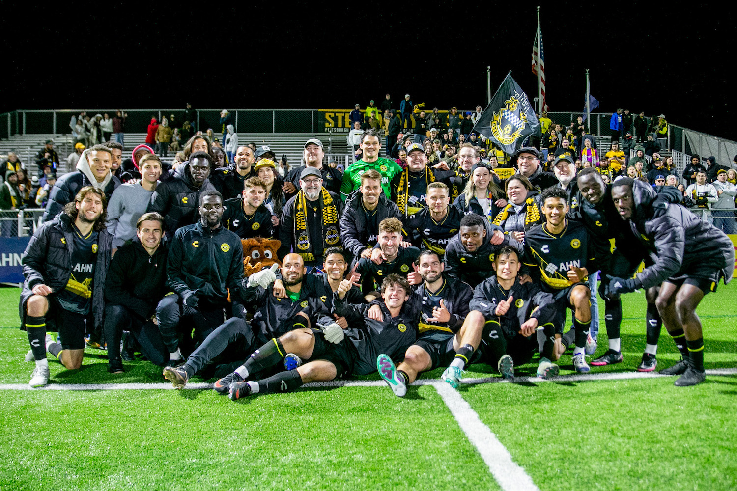 Riverhounds players and fans take a group photo while celebrating the Hounds' 2-0 win over El Paso Locomotive on Oct. 26, 2024, at Highmark Stadium. The win clinched the team's spot in the 2024 USL Championship Playoffs. (Photo: Chris Cowger/Riverhounds SC)