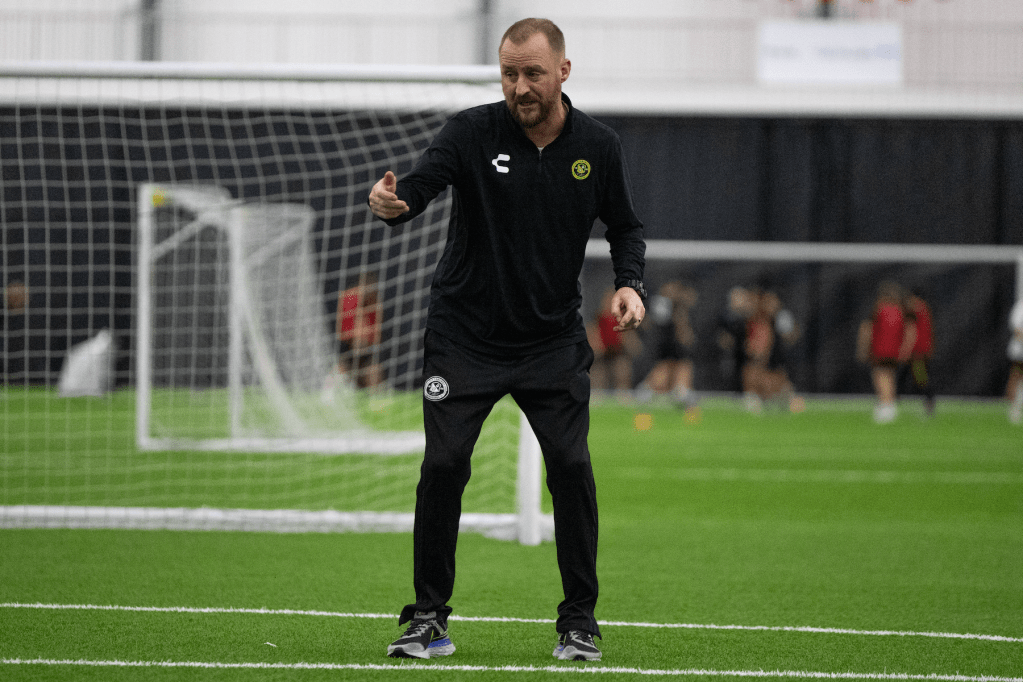 Riverhounds Academy coach Justin Evans gives instructions during a training session at AHN Montour. (Photo: Julia Wasielewski/Riverhounds SC)