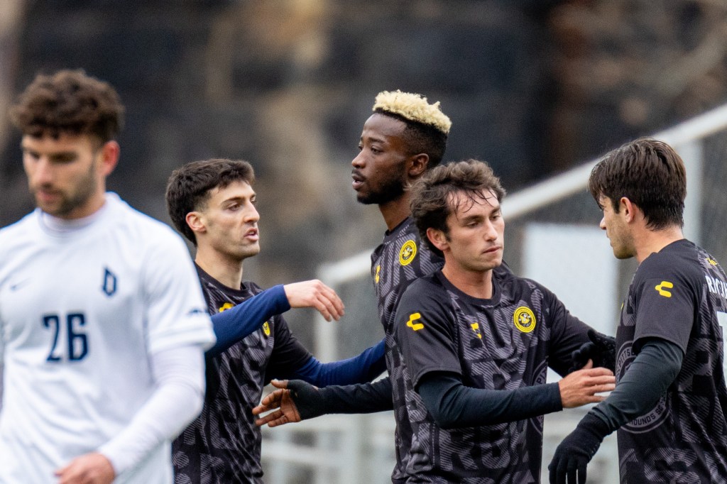 Riverhounds players congratulate one another after Augi Williams (center) scored the opening goal in the team's 3-0 preseason win over Duquesne University on Feb. 8, 2025 at Highmark Stadium. (Photo: Chris Cowger/Riverhounds SC)